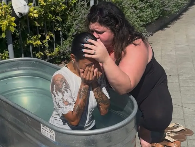 A woman held and prayed over in the baptism tank at Jesus Festival Hamilton 2026